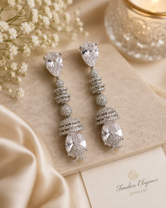 Silver-tone hoop earrings with clear stones.