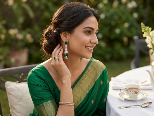 Silver-tone hoop earrings with green tones stones