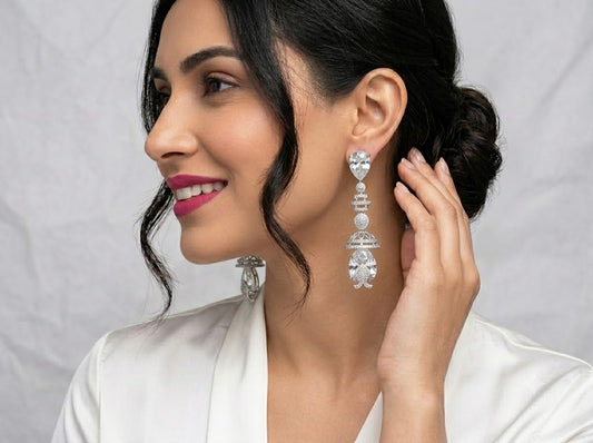 Silver-tone hoop earrings with clear stones.